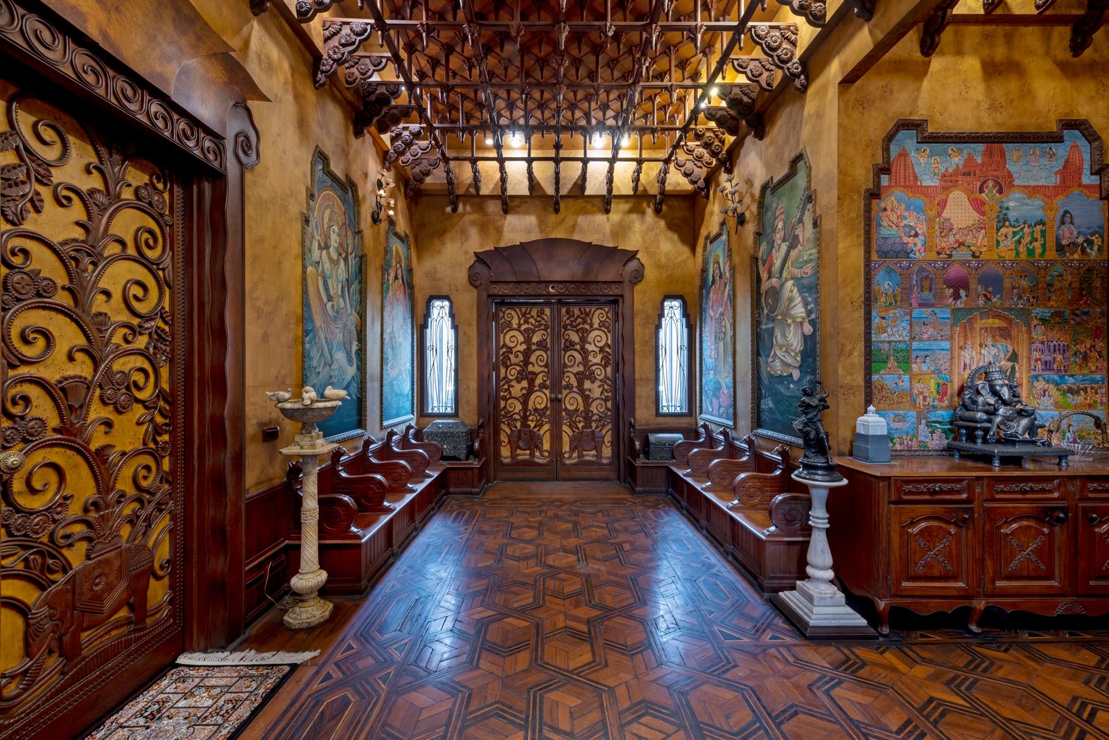 Carved Art Nouveau doors, murals and a parquet floor in the entrance hall